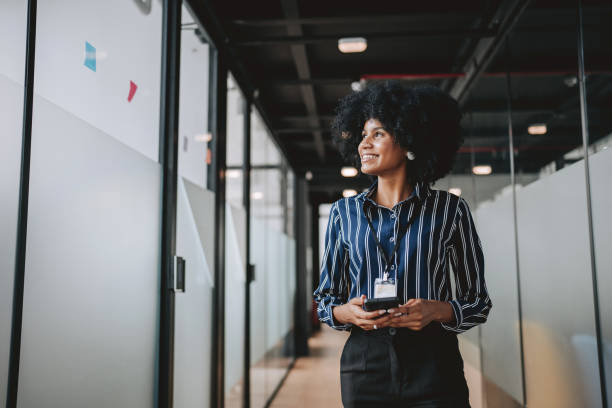 istock Young businesswoman using smart phone in modern office 2189387366