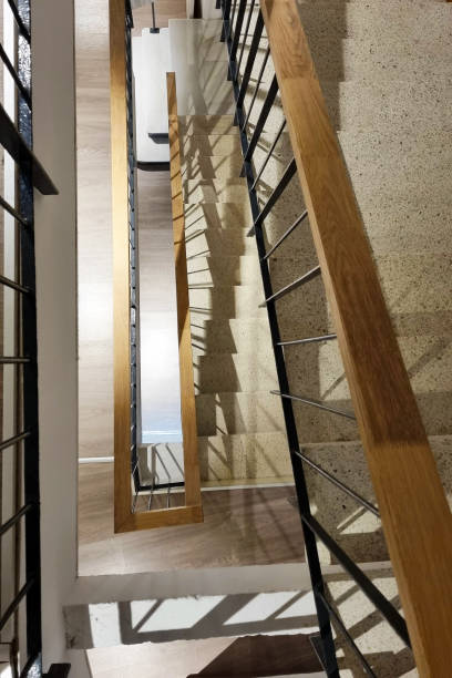 istock Modern Staircase Architecture with Wooden Handrails and Shadow Patterns 2189389732
