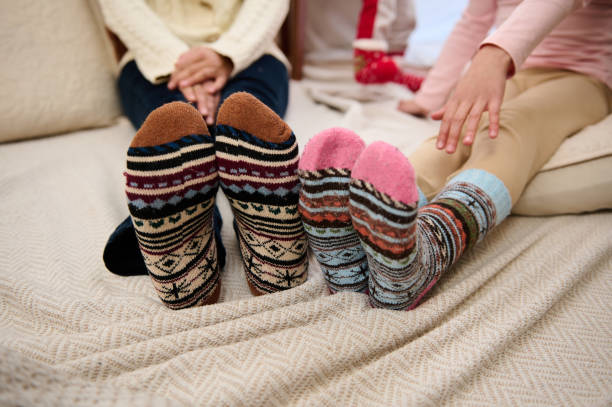 istock Colorful cozy socks on a bed capturing warmth and comfort 2189391939