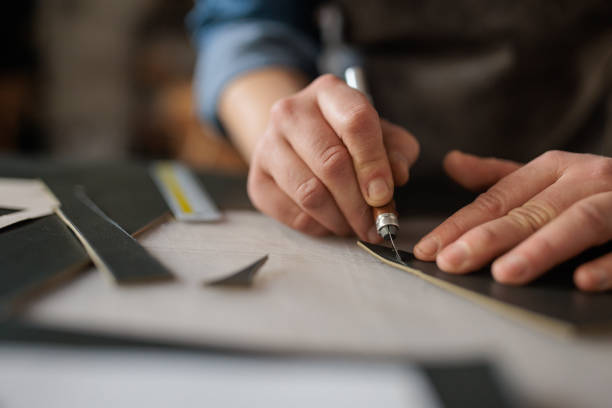 istock Skilled Craftswoman Cutting Leather 2189393260
