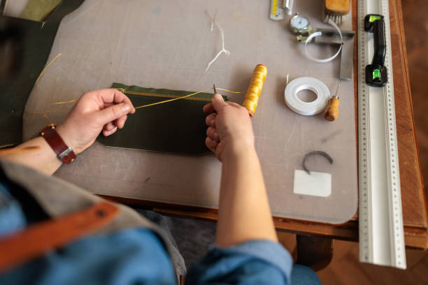 istock Skilled Craftswoman Making a Leather Wallet 2189395102