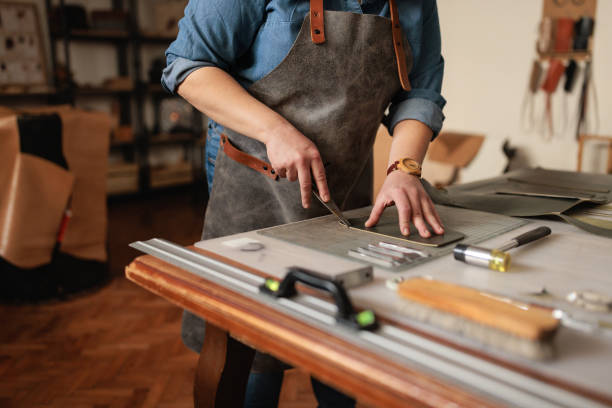 istock Craftswoman Handcrafting a Leather Wallet 2189395184