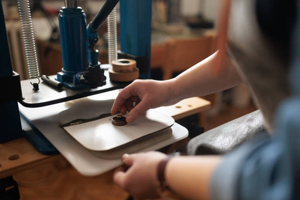 istock Craftswoman Adding Custom Seal to Leather Wallet 2189395409