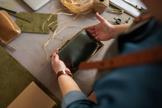 istock Woman Packaging Handmade Leather Wallet in Box for Shipping 2189398394