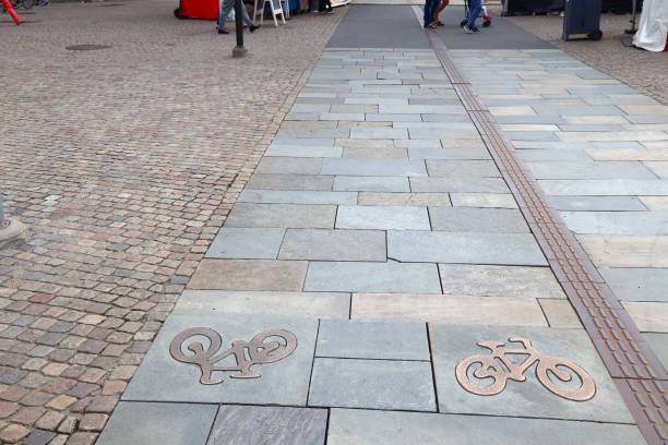 Stone paved bicycle path in Jonkoping, Sweden. Surface in old town made of flagstones. Cycling transportation infrastructure.
