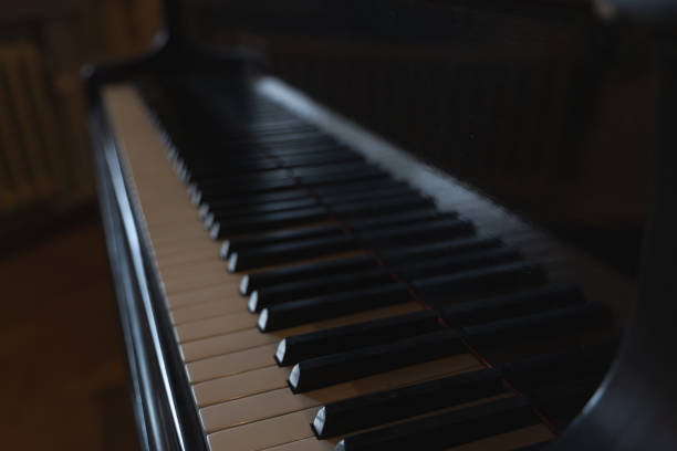 istock A black and white piano with a dark wood floor 2189402905