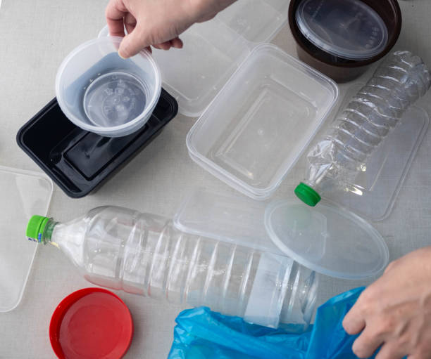 istock A men squeeze plastic bottle and putting in plastic bag for recycling and conservation environment stock photo 2189403616