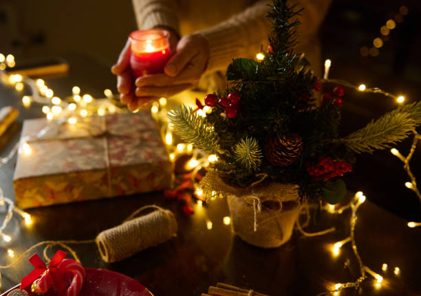 istock Cozy Christmas scene with candlelight and festive decorations on wooden table 2189403712