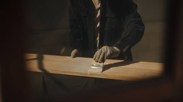 istock Man brush painting wooden plank. 2189405650