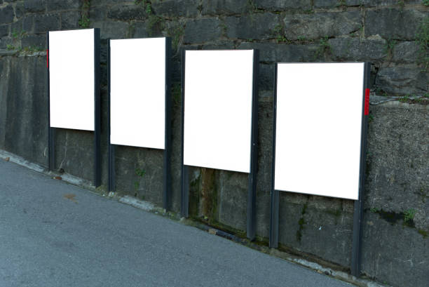 istock 4 white billboards on a steep street in Lugano. 2189405677