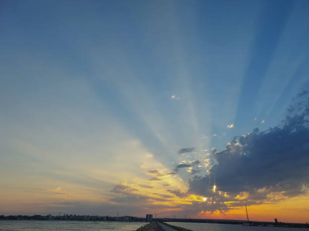 Berlin skyline at sunset, with a big yellow sun behind the clouds, Germany