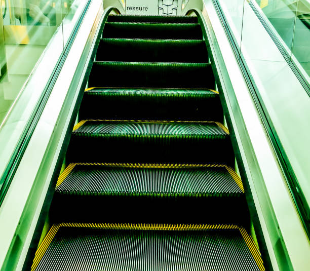 Top view of escalator stairs in shopping mall copy space