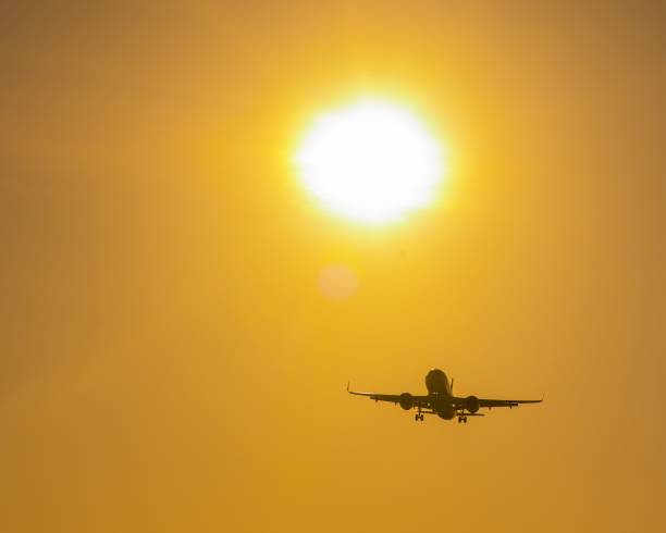 istock Bottom view of a flying plane at sunset. 2189417938