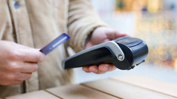 istock Customer paying with contactless credit card at pos terminal 2189418075