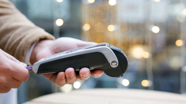 istock Cashier inserting credit card into pos terminal for payment 2189418081
