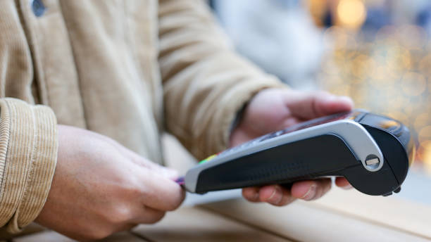 istock Customer inserting credit card into pos terminal for contactless payment 2189418090