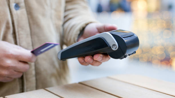 istock Customer paying with contactless credit card using nfc technology on pos terminal 2189418103
