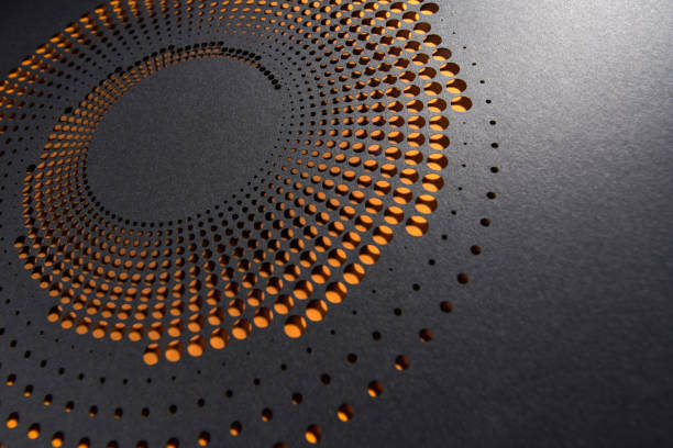 istock Elegant circular paper artwork with intricate dot patterns revealing warm orange layers beneath a black surface. 2189419199