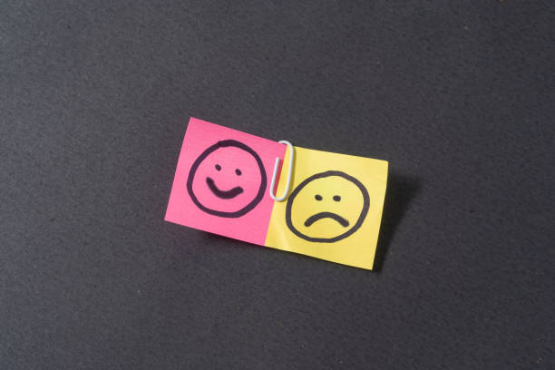 istock Smile and sad emoji on black background 2189419261
