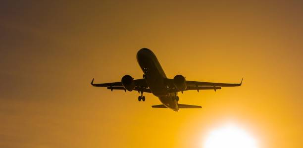 istock Bottom view of a flying plane at sunset. 2189419387