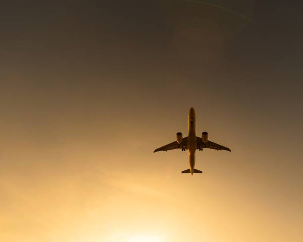 istock Bottom view of a flying plane at sunset. 2189422261