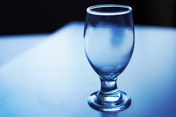 istock glass of wine cup on blue background 2189424450