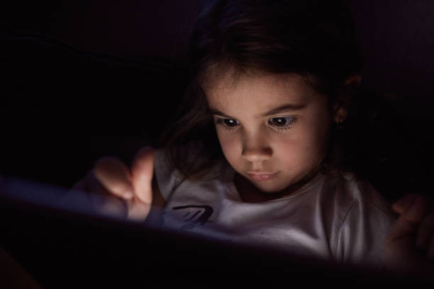 istock Small girl using tablet at night 2189425953