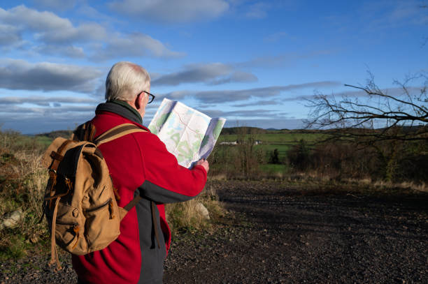 istock Retired man looking at a map in a rural location 2189428257