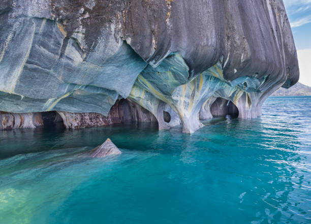 Marvel of the marble caves: a stunning view of a Cavern at the Santuario de la Naturaleza Capilla de Mármol on Lake General Carrera, Aysén, Southern Chile. The Santuario de la Naturaleza Capilla de Mármol, located on the turquoise waters of Lake General Carrera in Aysén, southern Chile, showcases nature's artistry at its finest. This breathtaking image captures the intricate details of a marble cavern, where centuries of water erosion have sculpted stunning patterns and shapes, creating a mesmerizing natural wonder. carretera austral chile stock pictures, royalty-free photos & images