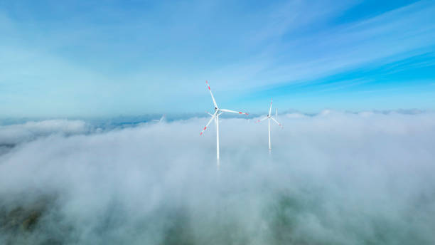 istock Wind turbines, fog and clouds on hills 2189430439