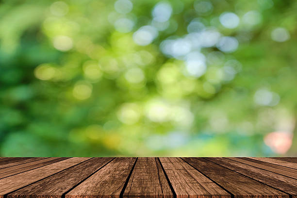 istock Wood table and forest background for show product or graphics design. 2189431773