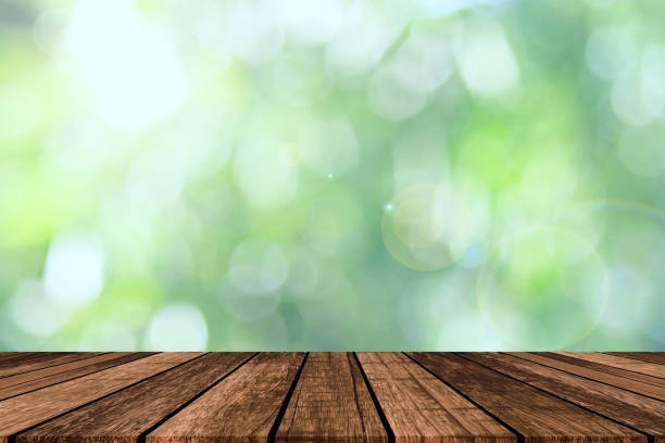 istock Wood table and forest background for show product or graphics design. 2189431791