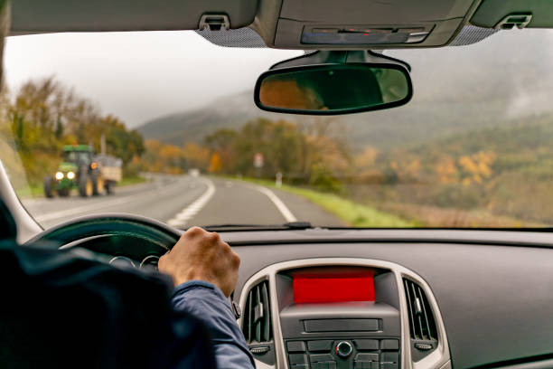istock Driving down a foggy autumn rural road. 2189432026