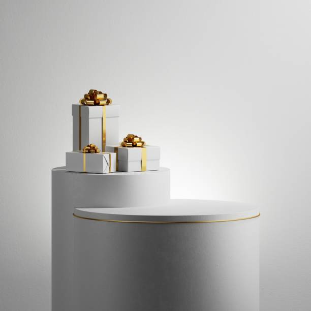 istock 3d render. Abstract minimalist white background. Wrapped gift boxes with gold ribbons placed on high podiums. Holiday showcase, mockup for product presentation 2189432558