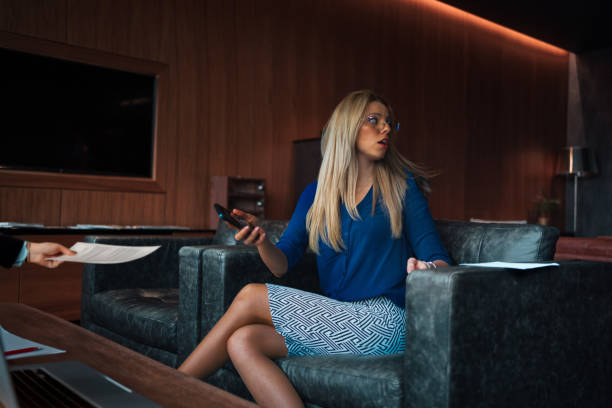 istock Focused Businesswoman Discussing Documents in a Meeting 2189432994