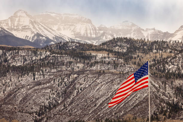 istock Beautiful American Flag in the Snowy Mountains 2189434591