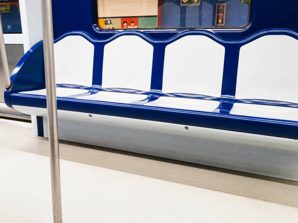 Seats without people in an underground subway car standing at a city station.