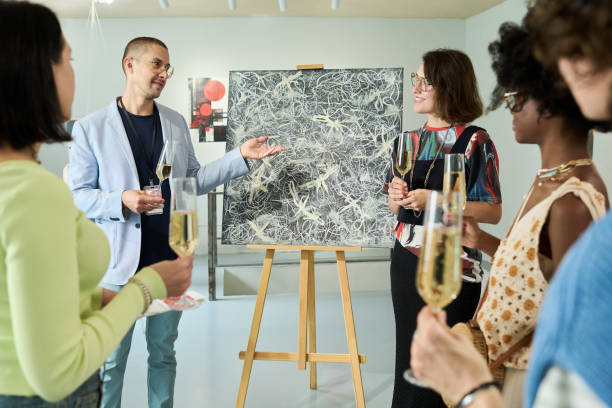istock Man pointing at painting on easel 2189437639