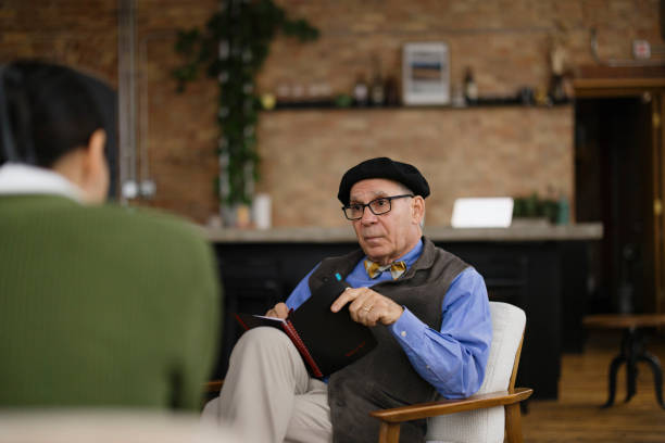 istock Senior Man in Discussion Session with Colleague at Rustic Workplace 2189440012
