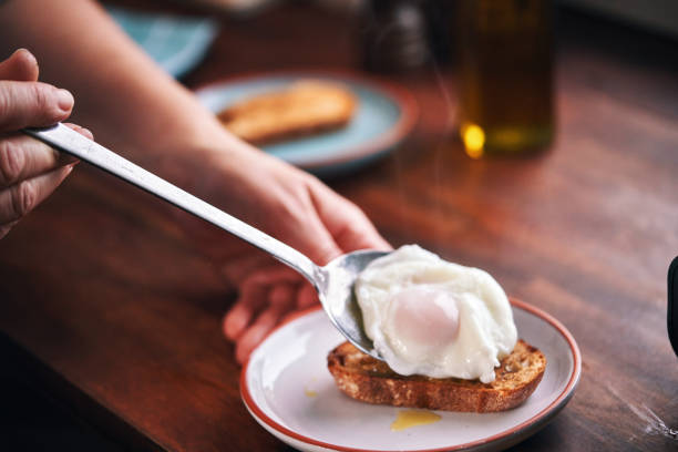 istock Poached Egg on Brown Bread Served with Ham, Avocado and Sauce Hollandaise 2189443159
