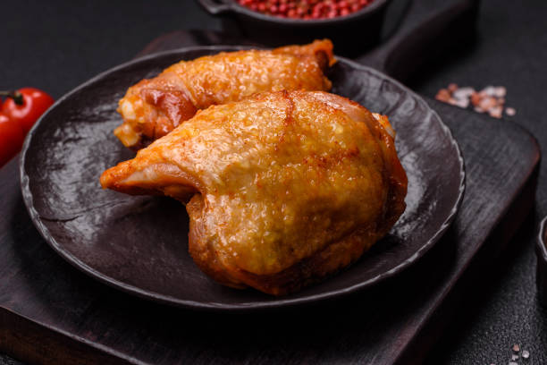 istock Chicken thighs fried with salt, spices and herbs 2189443913