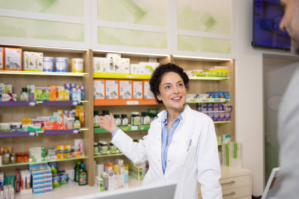 istock Pharmacist Assisting Customer in a Modern Pharmacy Store with Organized Shelves 2189444485