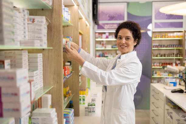 istock Pharmacist Organizing Medicine in a Bright and Well-Stocked Pharmacy 2189444492