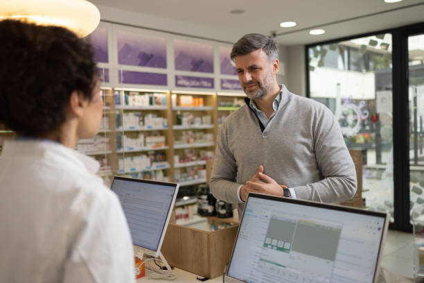 istock Customer Consulting With Pharmacist at Pharmacy Counter 2189444499