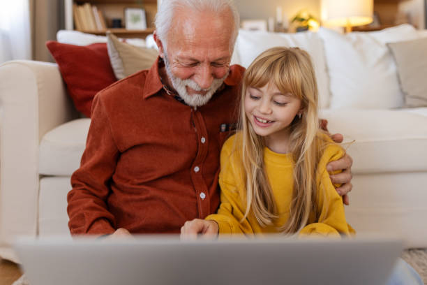 istock Tech-Savvy Grandpa and Granddaughter Exploring the Laptop 2189446187