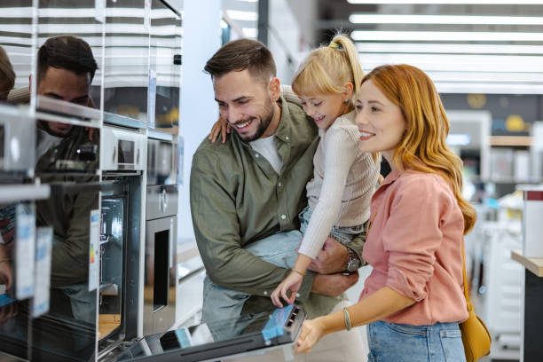 istock Happy family examining a modern oven in an electronics store 2189448771