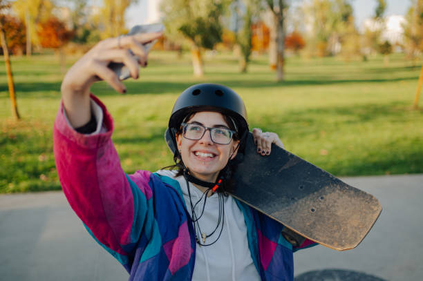 istock Skater taking selfie while holding skateboard on shoulder 2189450664