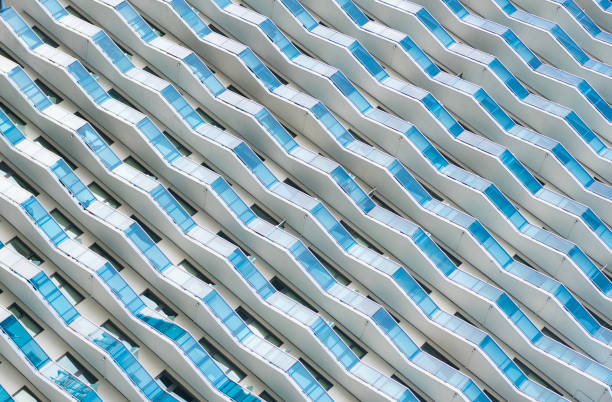 Background of architecture. Modern glass background. Glass facade background. Architecture. Building architecture. Building background. Glass building with geometric balcony. Architectural detail.