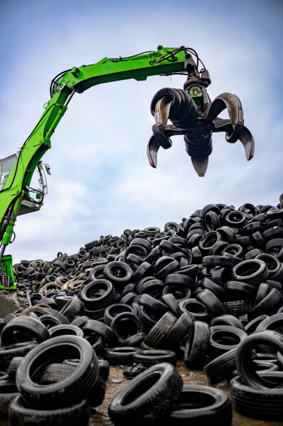 istock Industrial machine lifting and transfering used tires for recycling 2189452349