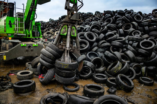 istock Crane hook picking up stacked tires at the landfill 2189452445